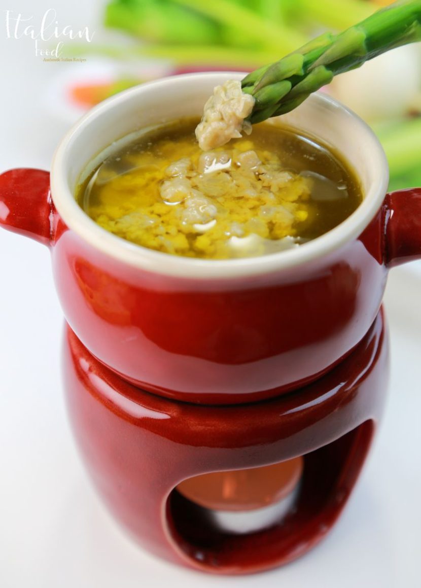 How to Make Authentic Bagna Cauda (Hot Dip) Plate of authentic Bagna Cauda (Hot Dip) with fresh vegetables.