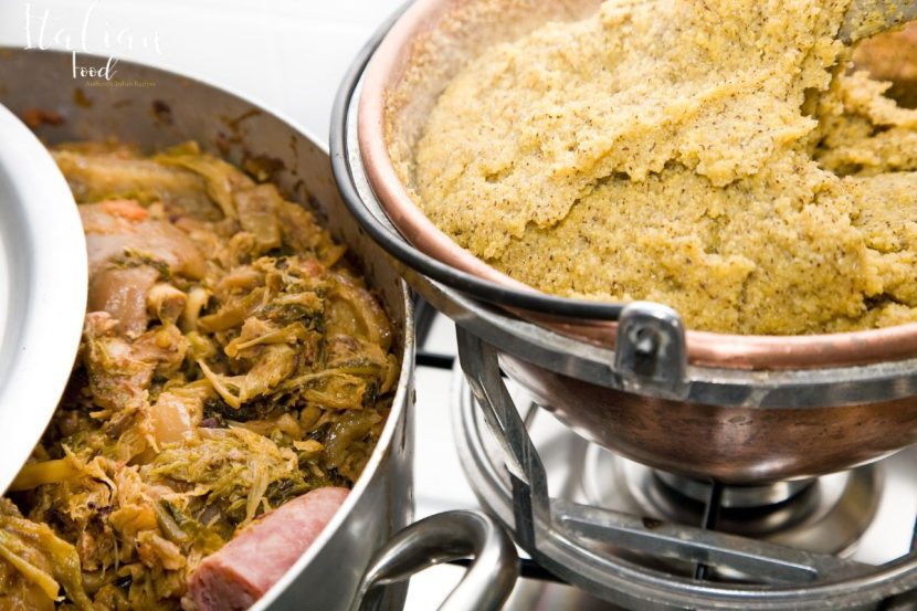 A bowl of hearty Cassoeula stew with pork and cabbage, garnished with fresh parsley.