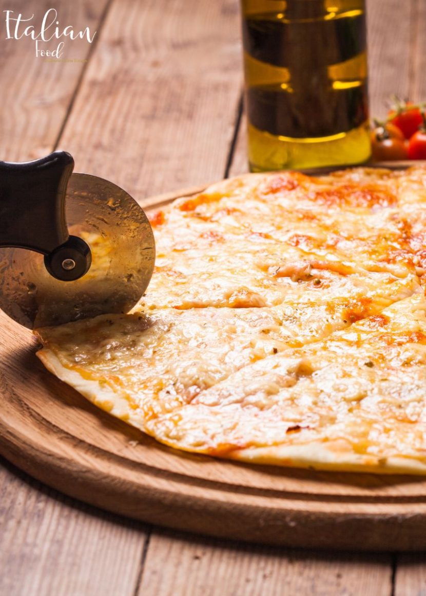 White Pizza garnished with fresh basil leaves.