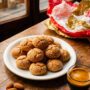 A pile of crunchy Amaretti di Saronno vera ricetta on a vintage plate next to a cup of espresso.
